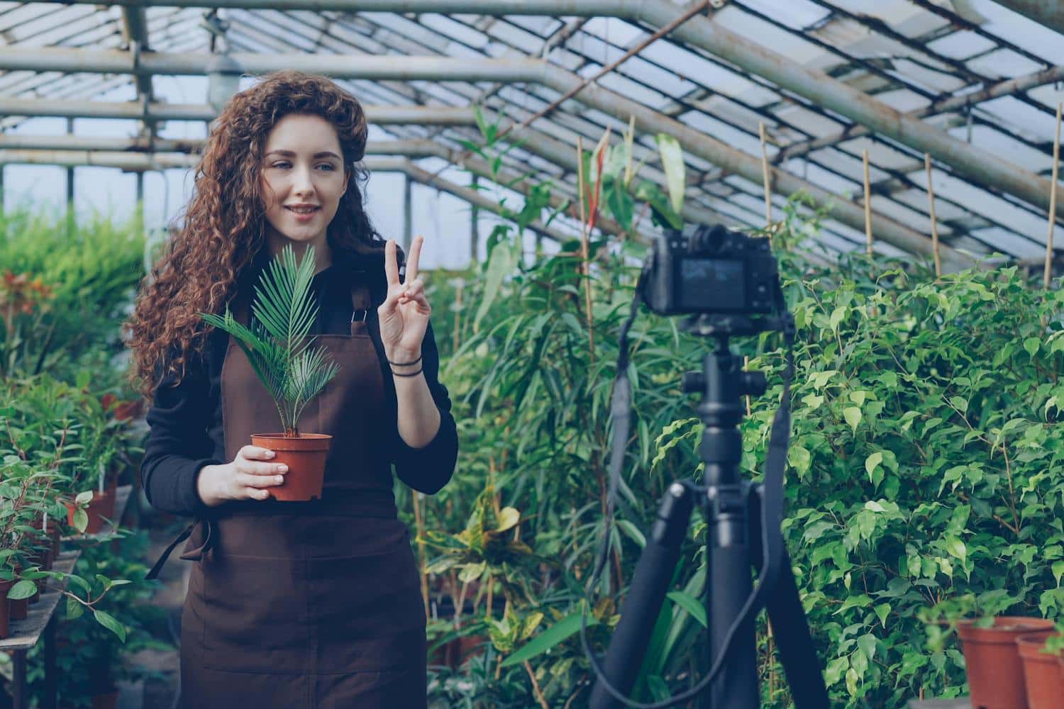 A woman working on content creation in a beautiful garden setting